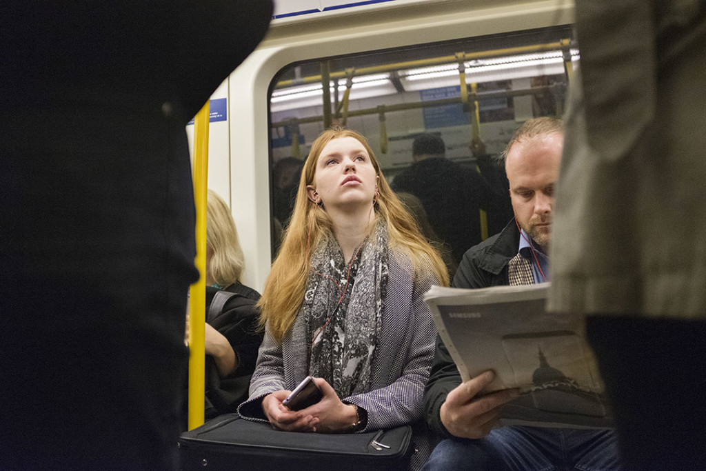 young red haired woman in a london underground train