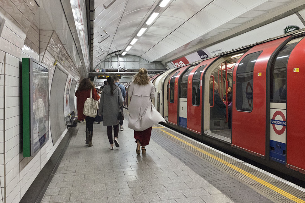 people moving along a London underground quay